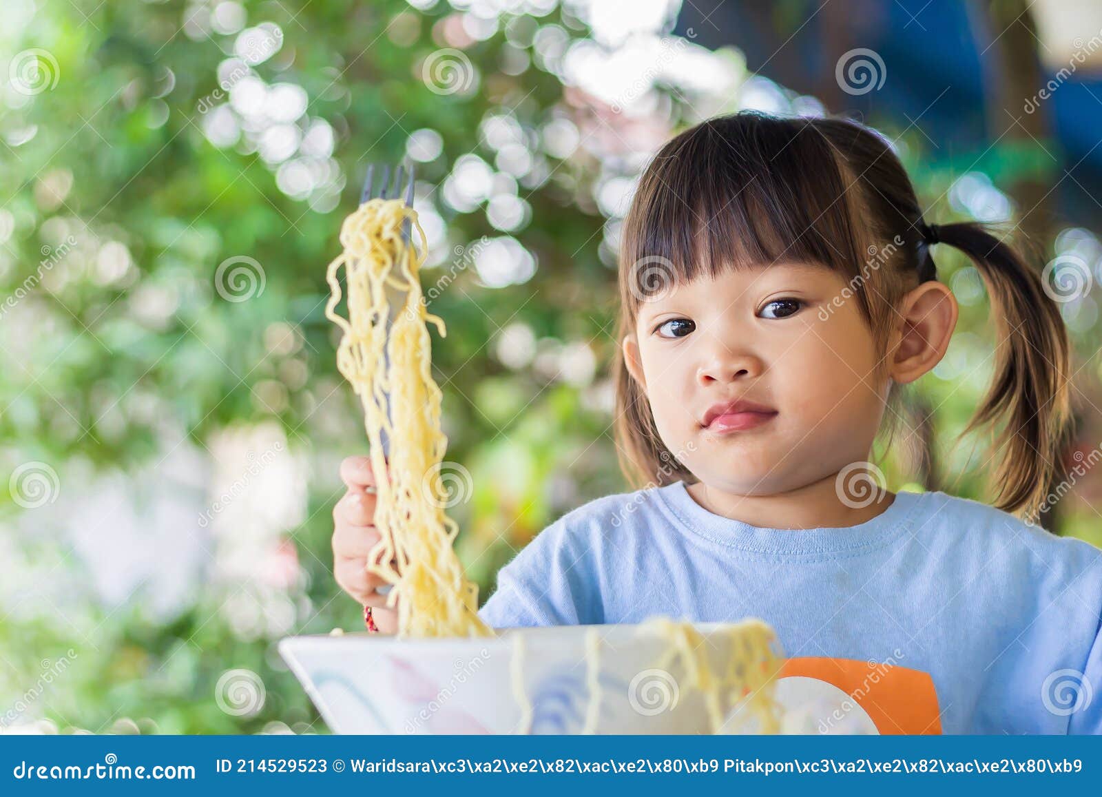 portraitÃ¢â¬â¹ imageÃ¢â¬â¹ ofÃ¢â¬â¹ 2-3 yearsÃ¢â¬â¹ oldÃ¢â¬â¹ ofÃ¢â¬â¹ baby.Ã¢â¬â¹ happyÃ¢â¬â¹ asianÃ¢â¬â¹ childÃ¢â¬â¹ girlÃ¢â¬â¹ enjoyÃ¢â¬â¹ eatingÃ¢â¬â¹ someÃ¢â¬â¹